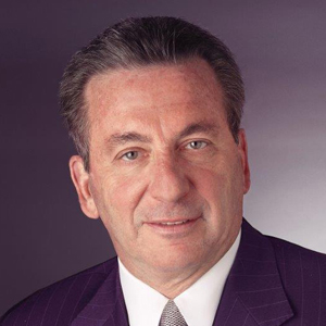 Maxx Properties Chairman, Robert Wiener, in a professional headshot wearing a purple suit and tie, endorsing SPRING Design + Architecture